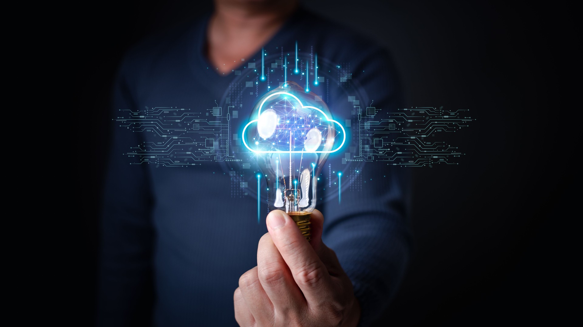 a person holding a lightbulb with a glowing, futuristic cloud hologram inside, surrounded by digital circuitry and connections, symbolizing innovation and cloud-based technology.